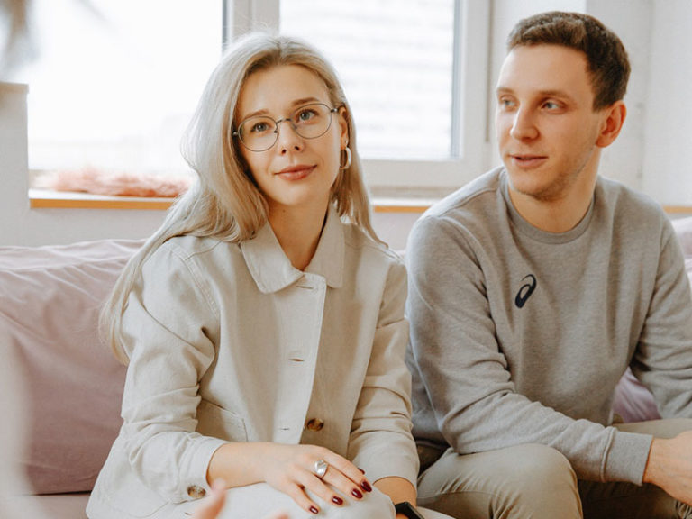 Couples in couples therapy sitting on the therapists couch