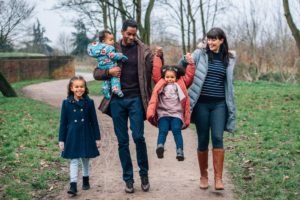 Family walking down the road outside in autumn