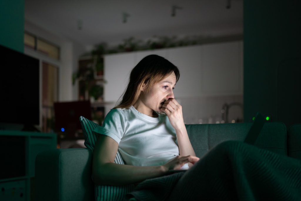 woman staring at computer screen applying for therapy