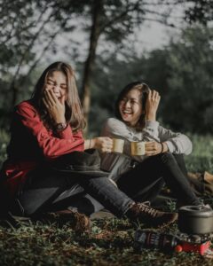 Two happy girls on a camping treat